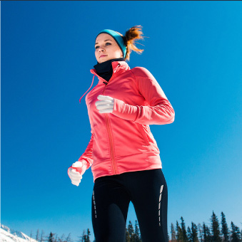 services-1 Woman wearing thermoregulation clothing jogs in the snow.